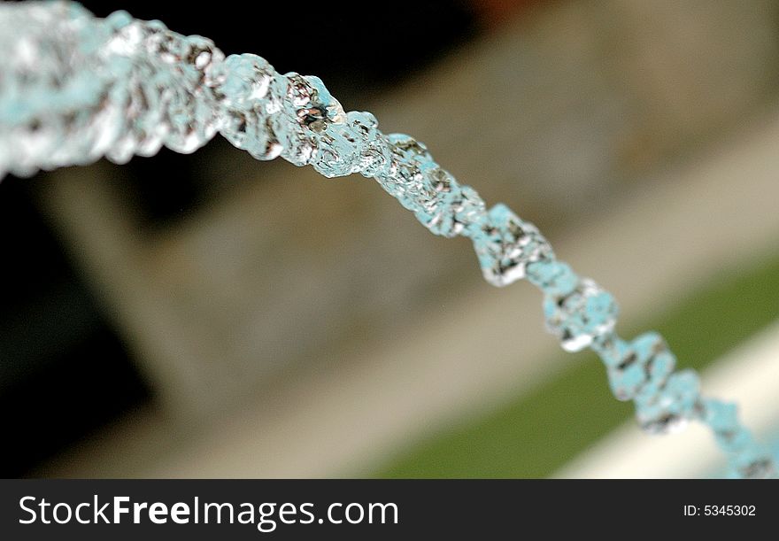 A stream of water running from a sculpture