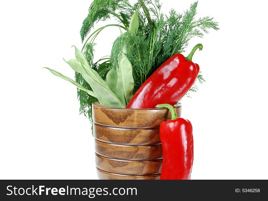 Fresh green beans, red pepper and dill placed in wooden herb cup