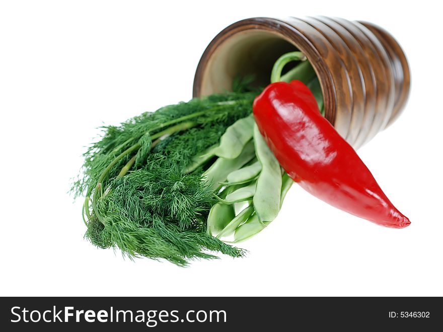 Fresh green beans, red pepper and dill placed in wooden herb cup