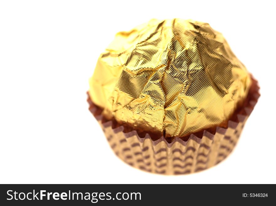 Chocolate sweet on golden foil wrapping. Chocolate sweet on golden foil wrapping