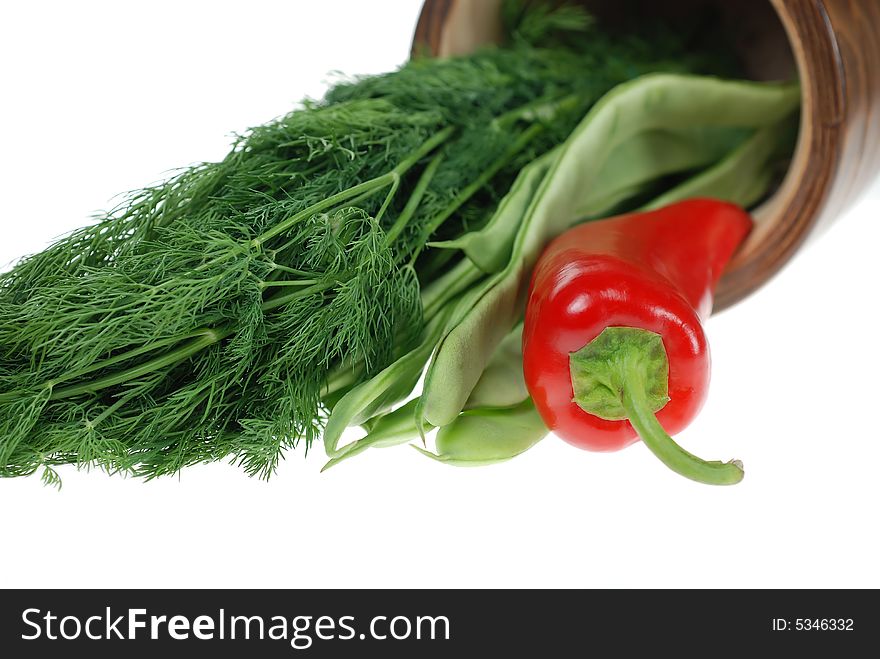 Fresh green beans, red pepper and dill placed in wooden herb cup