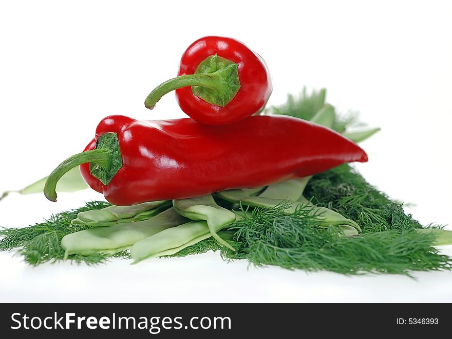 Fresh red pepper placed on green beans and dill