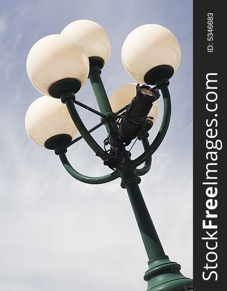 Close up view of a city lamp with a blue sky
