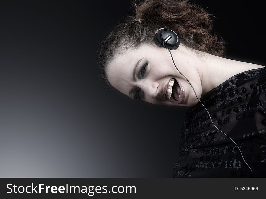 Portrait of a woman with long curly hair and headphones. Portrait of a woman with long curly hair and headphones