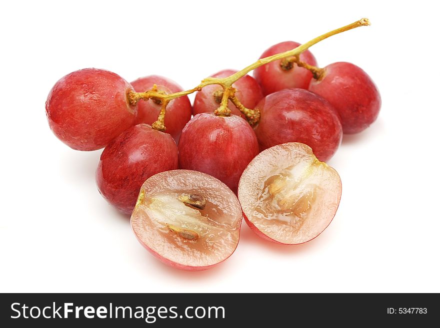 A string of grapes with the slices over white background.