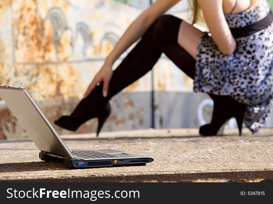 Casual shot with long legs and laptop