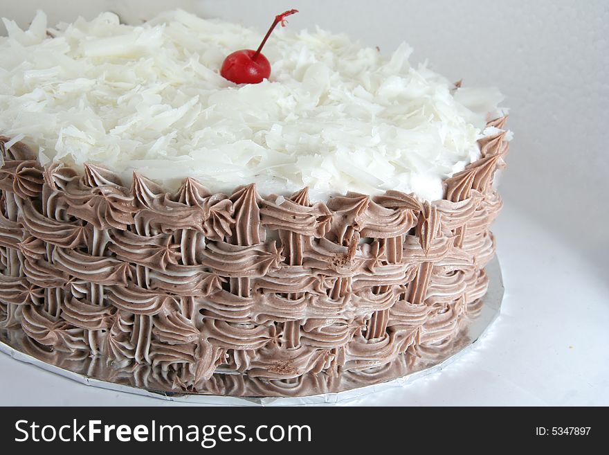 Chocolate cake with grated white chocolate on it