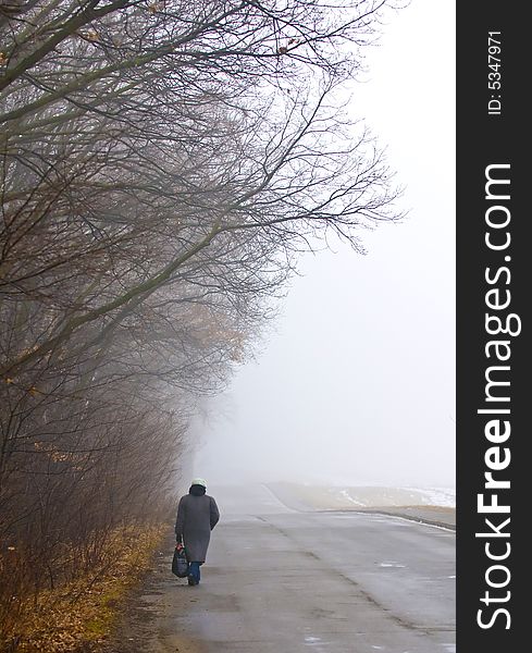 Woman walking in foggy day in the ukranian countryside. Woman walking in foggy day in the ukranian countryside