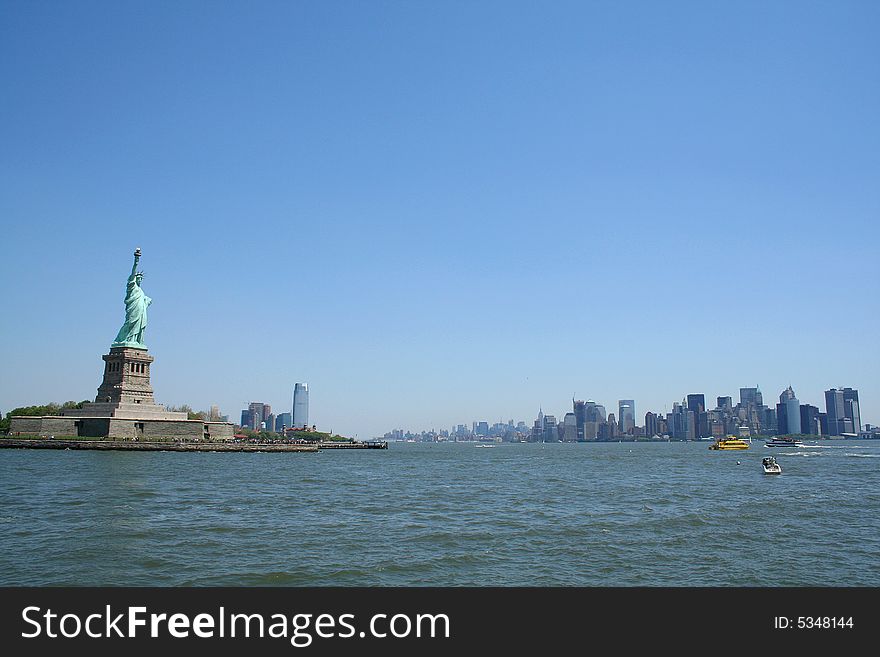 Statue of Liberty and downtown Manhattan in background as viewed from the ferry