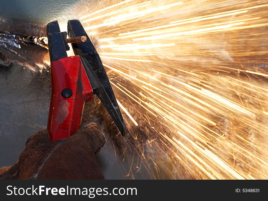A close up of a worker arcing steel. A close up of a worker arcing steel