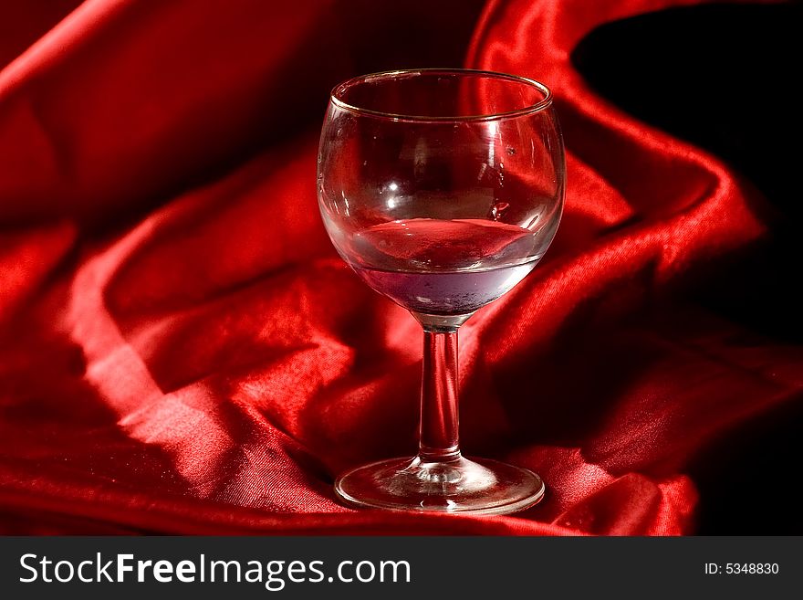 A glass of water over a red background. A glass of water over a red background