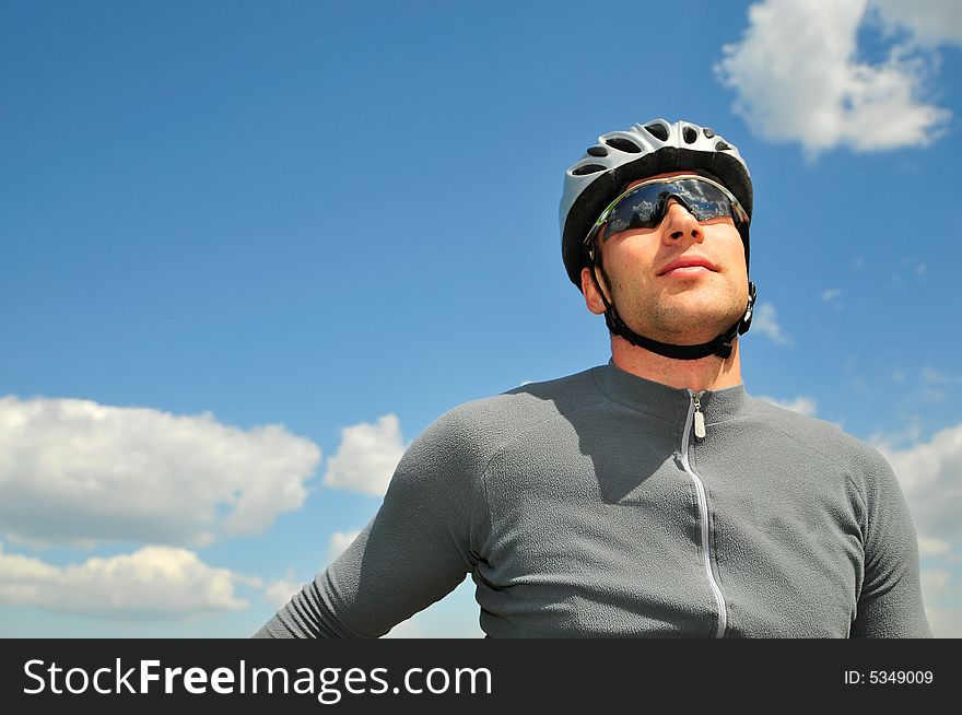 Bicyclist on a background of the blue sky. Bicyclist on a background of the blue sky