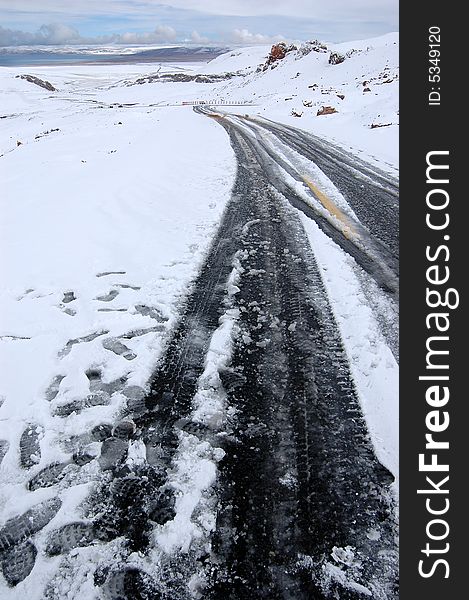 The asphalt road through the rigid thick snow and ice land in Tibet,Qinghai-Tibet Plateau,China. The asphalt road through the rigid thick snow and ice land in Tibet,Qinghai-Tibet Plateau,China.