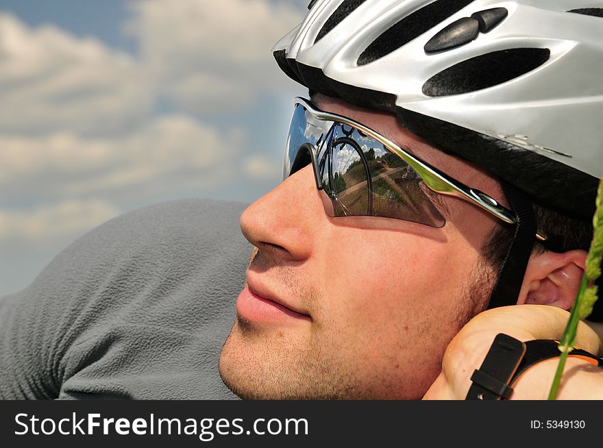 Bicyclist on a background of the blue sky. Bicyclist on a background of the blue sky