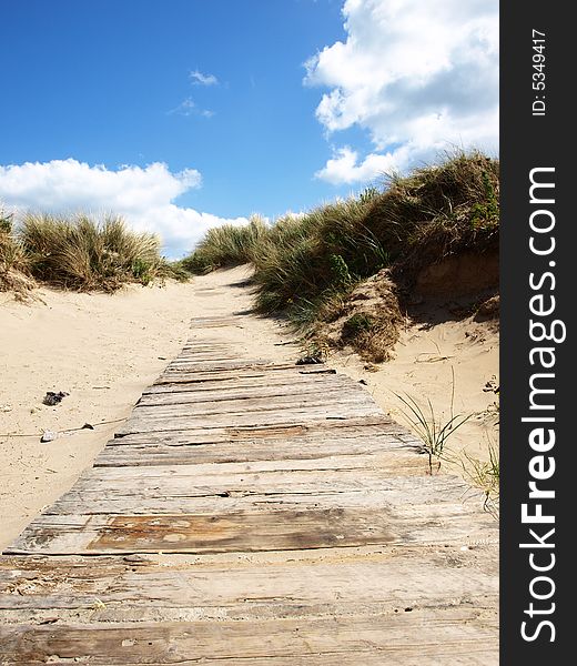 Wooden and sandy pathway to beach