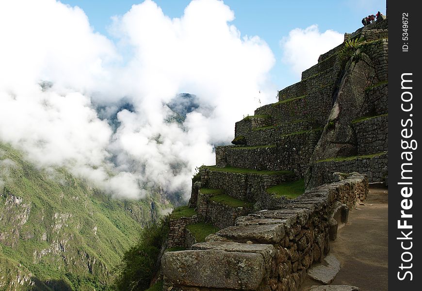 The lost city of the inca Machu Picchu in Cuzco, Peru. Inca window. Machu Picchu cover with clouds.