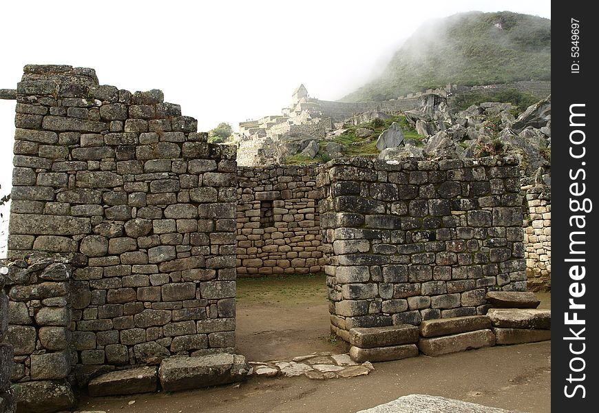 The lost city of the inca Machu Picchu in Cuzco, Peru. Inca window. Machu Picchu cover with clouds.