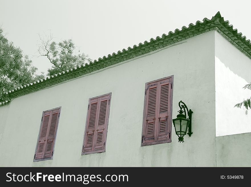 An old house in the area of Plaka in Athens Greece; the image (except for the windows) has be converted to monochrome with green tone. An old house in the area of Plaka in Athens Greece; the image (except for the windows) has be converted to monochrome with green tone