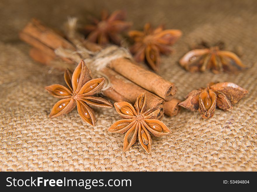 Few star anise and cinnamon sticks on old cloth