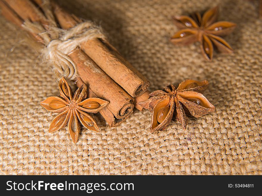 Few star anise and cinnamon sticks on old cloth