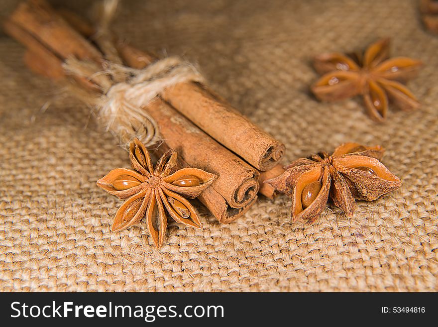 Few star anise and cinnamon sticks on old cloth