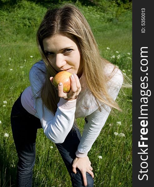 Cute girl with apple outdoor