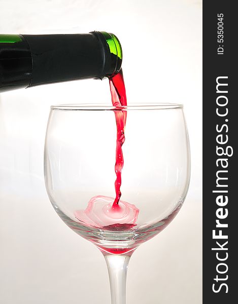 Pouring a glass of red wine. Pouring a glass of red wine