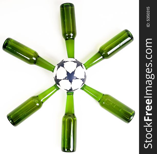 Beer bottles forming a star around a soccer ball. Beer bottles forming a star around a soccer ball