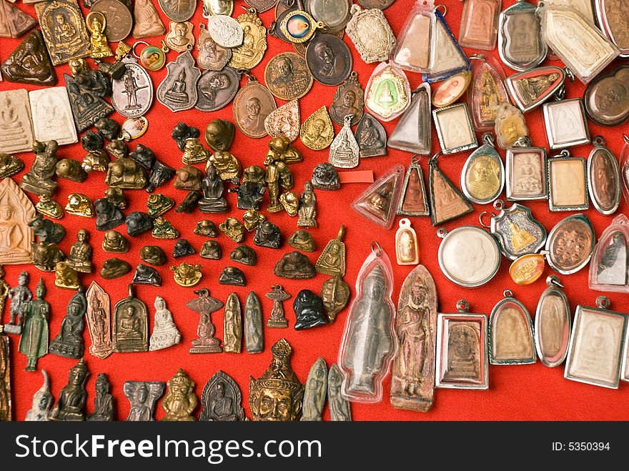 A series of metal and clay Buddhist amulets from a market in Bangkok
