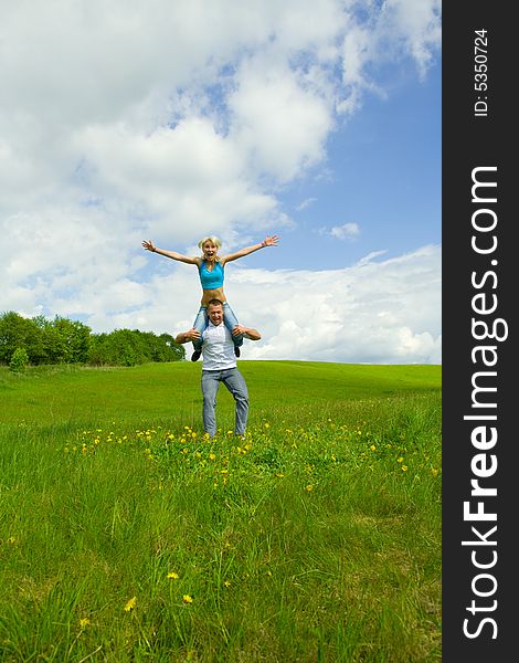 Young family jumping on a lawn