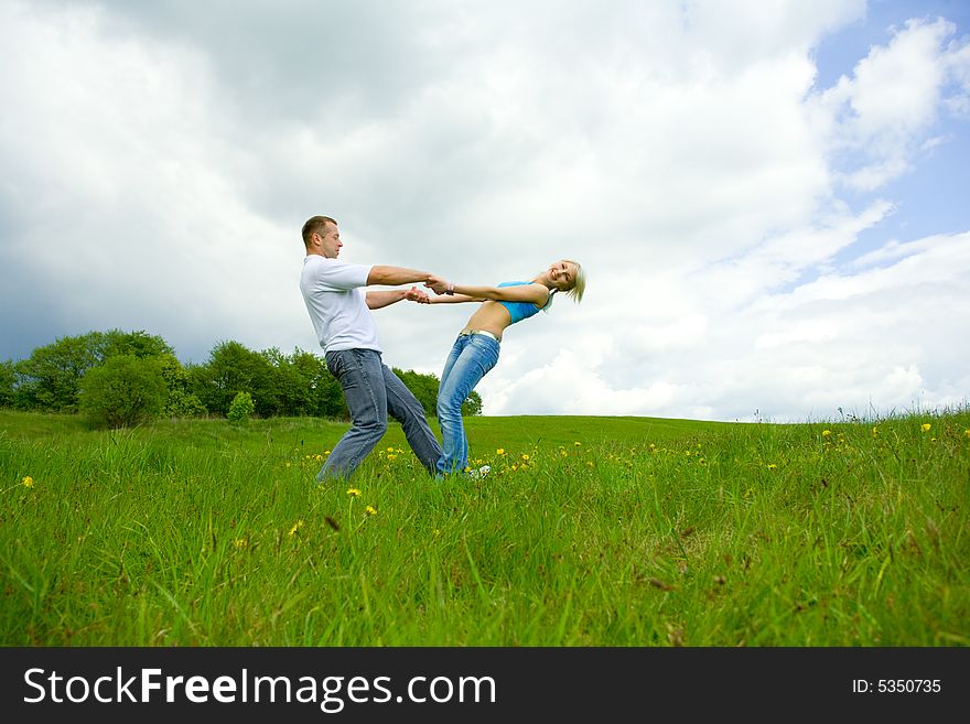 Young family jumping on a lawn