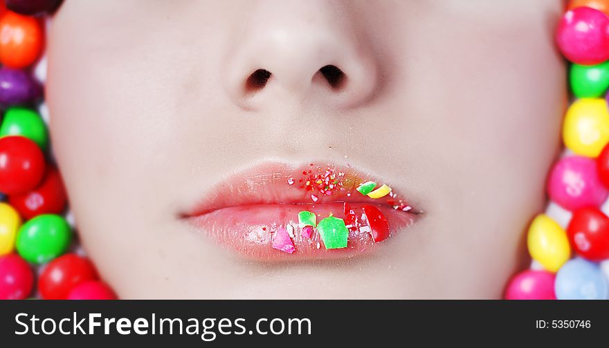Lips of young beauty girl in candys