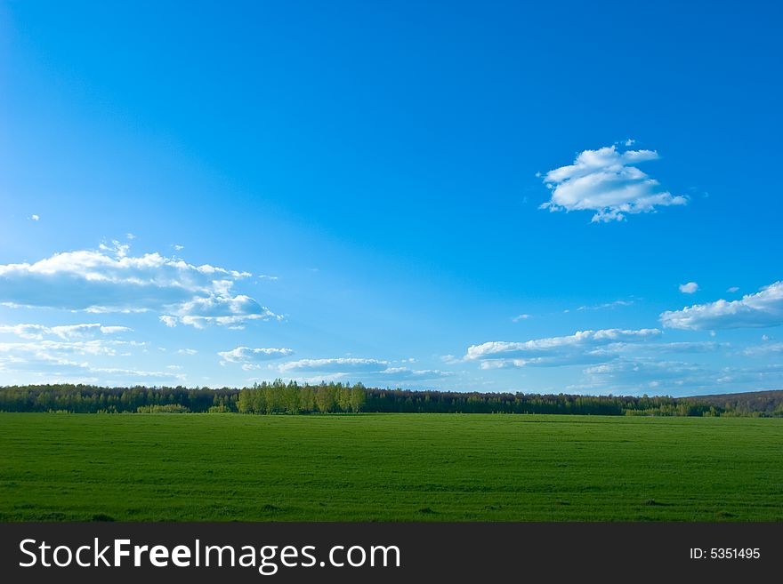 Green field under Blue sky with clouds. Green field under Blue sky with clouds