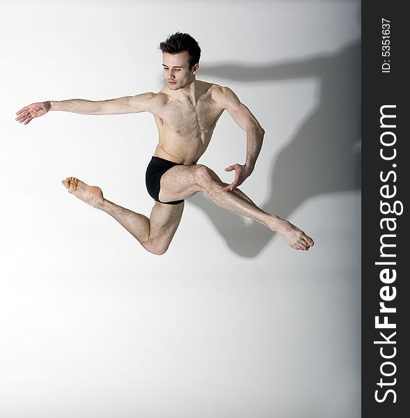 Young professional muscular male dancer leaping. Young professional muscular male dancer leaping