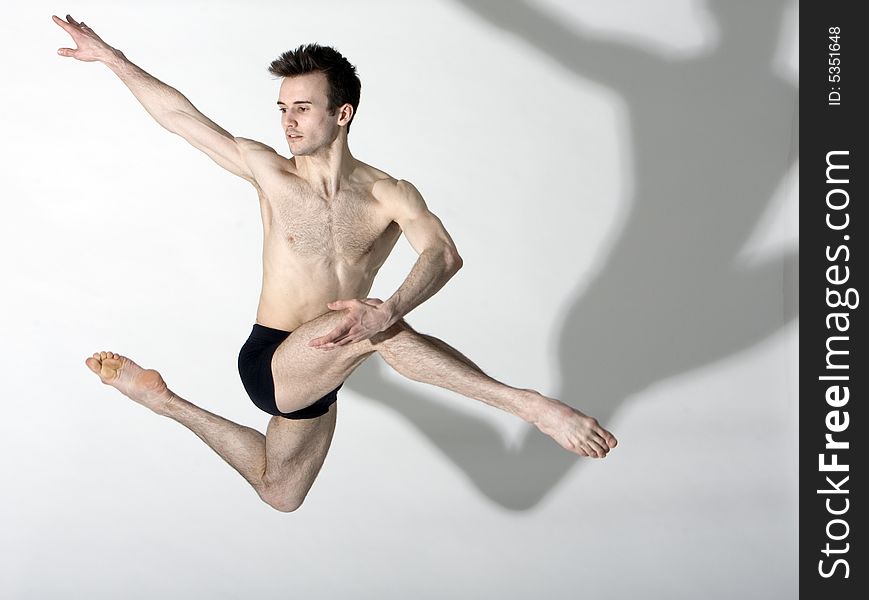 Young flexible male dancer leaping. Young flexible male dancer leaping