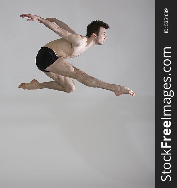 Muscular professional male dancer leaping. Muscular professional male dancer leaping