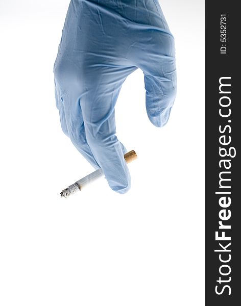 Glove of a doctor with a cigarette. Glove of a doctor with a cigarette