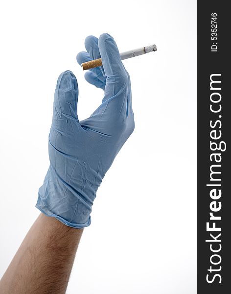 Glove of a doctor with a cigarette. Glove of a doctor with a cigarette