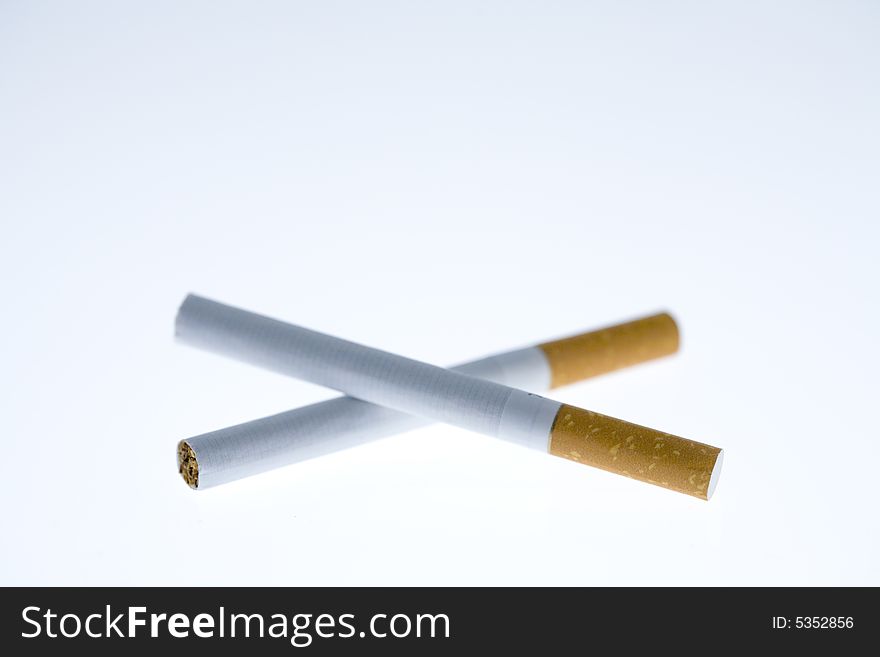 Two intertwined cigarettes on a white background
