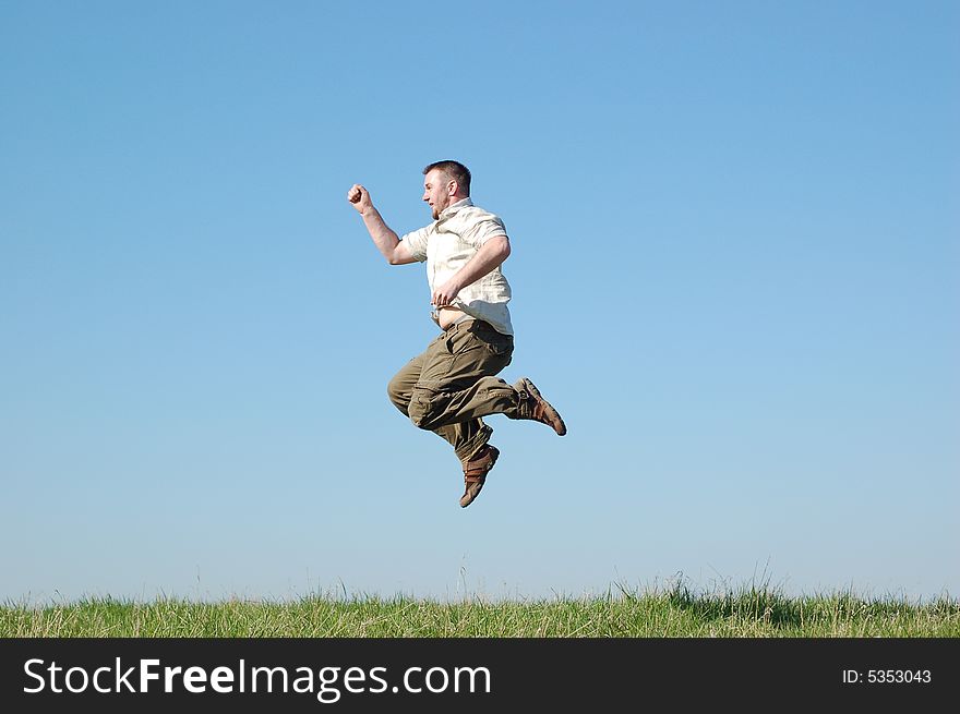 Happy man jumping on green meadow. Happy man jumping on green meadow