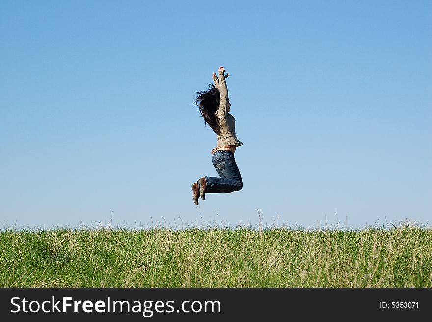 Happy woman jumping on green meadow. Happy woman jumping on green meadow