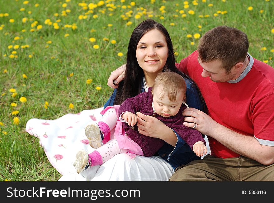 Happy family together on green meadow