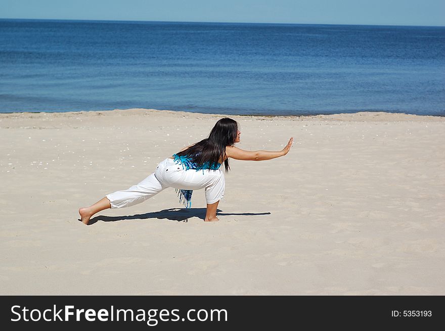 Woman doing exercise on the beach. Woman doing exercise on the beach