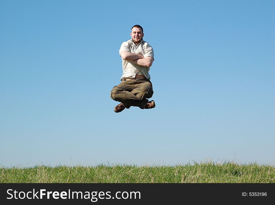 Happy man jumping on green meadow. Happy man jumping on green meadow