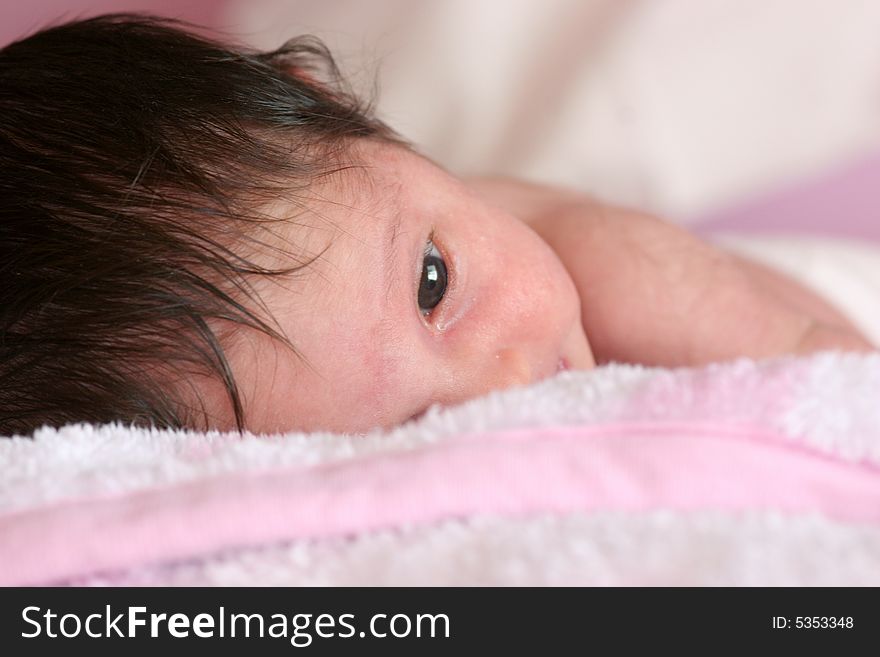 Little newborn caucasian girl lying