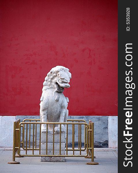A traditional chinese stone lion sitting in the left side of the door, shot at Zhongshan park, Beijing China.