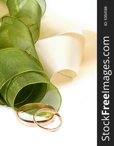 Wedding rings and tape on white background