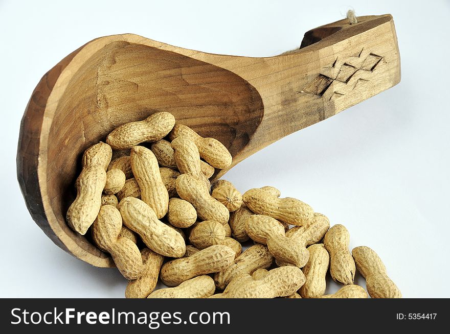 Hand made wooden sponn full with peanuts