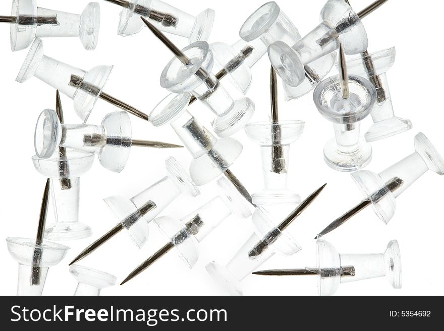 Pile of Clear Thumbtacks on a White Background