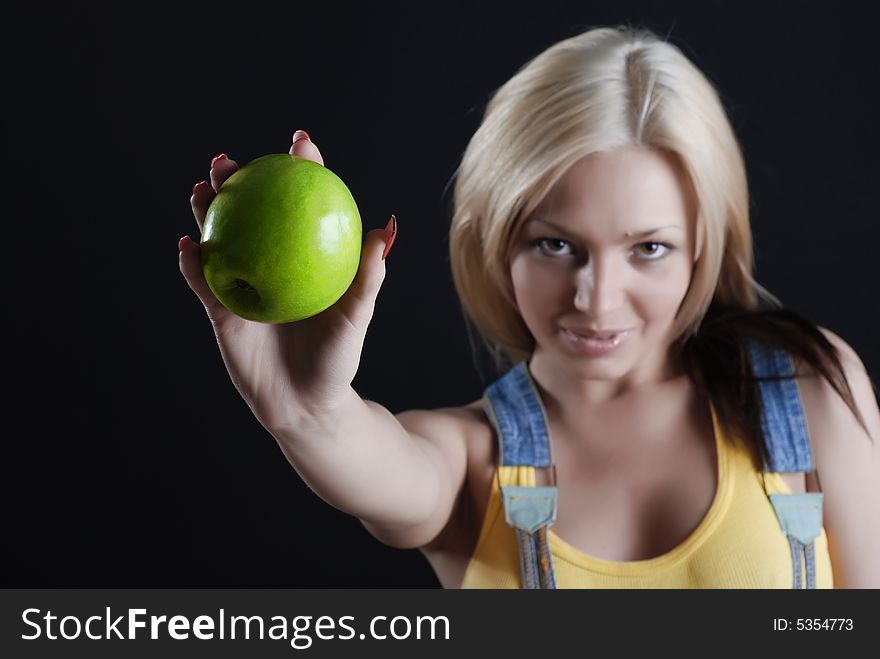 The person of the beautiful girl with a green apple in a hand and red manicure. The person of the beautiful girl with a green apple in a hand and red manicure